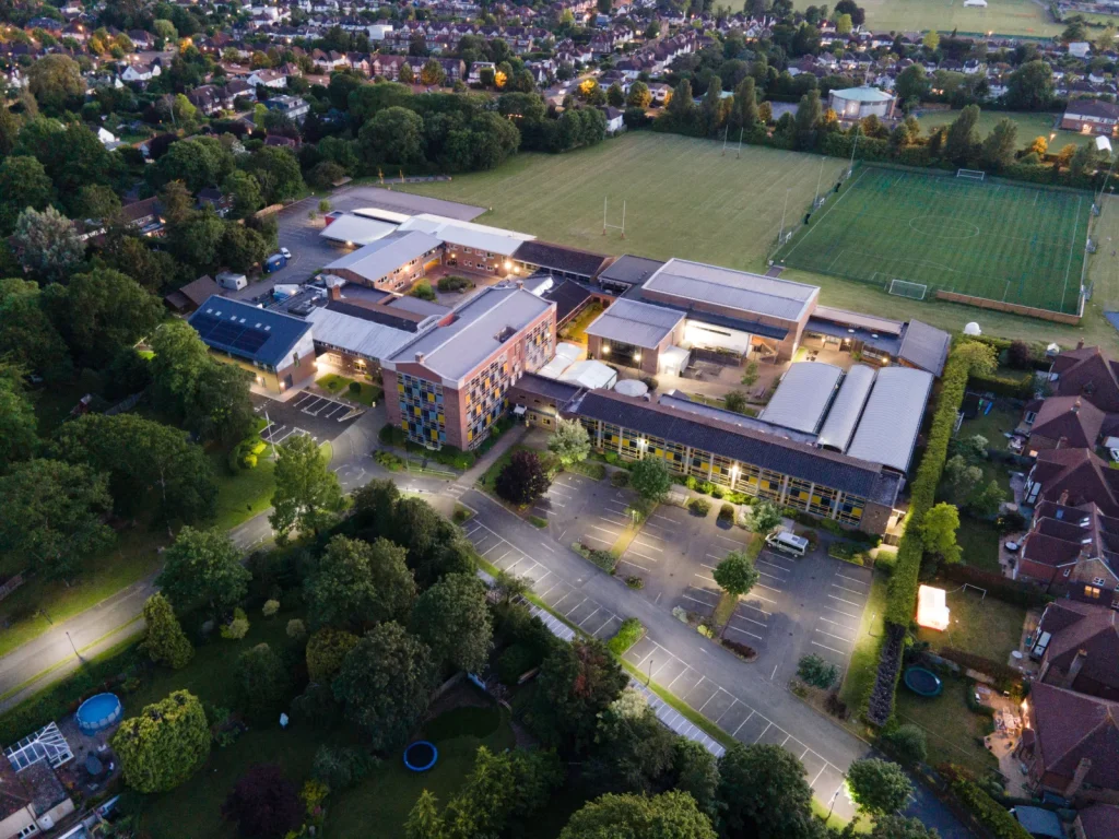Aerial view of a UK secondary school building and grounds at dusk