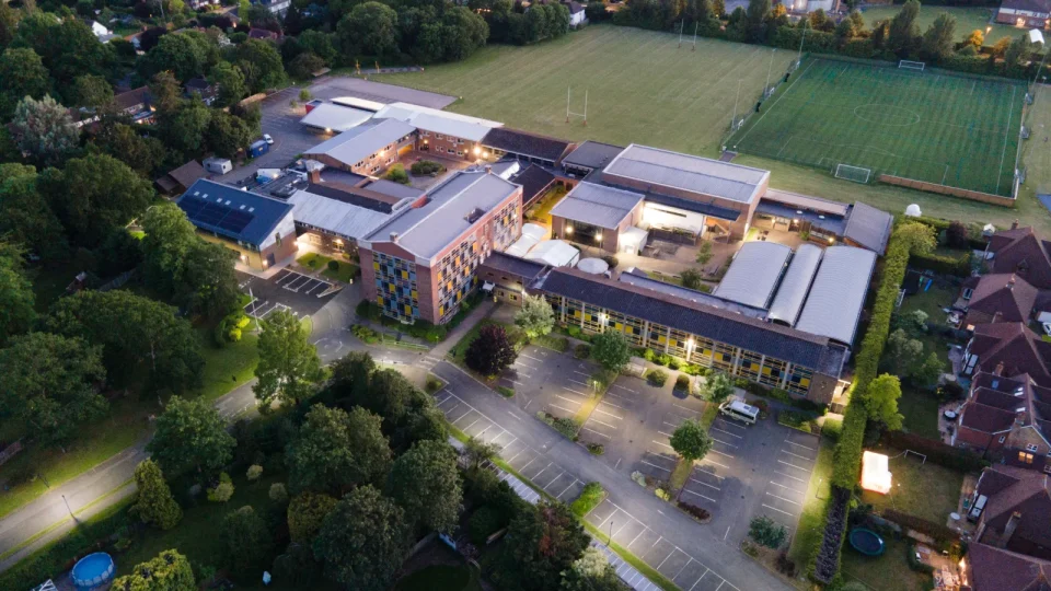 Aerial view of a UK secondary school building and grounds at dusk