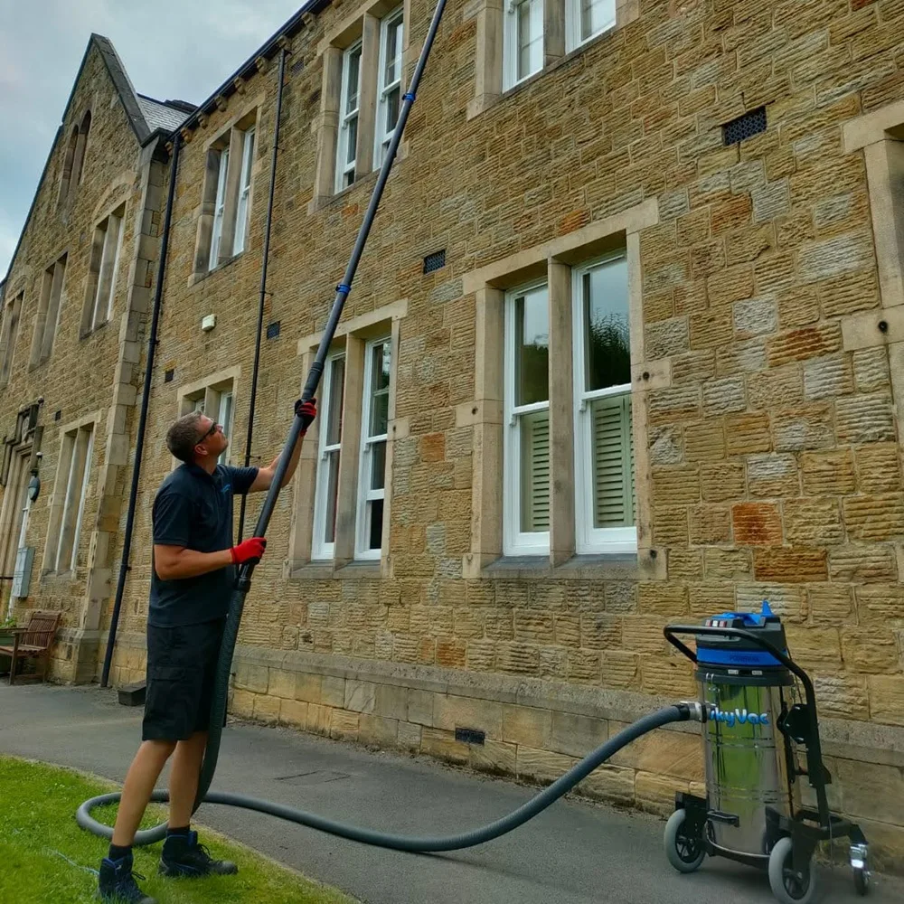 Clearing gutters from the ground with a gutter vacuum