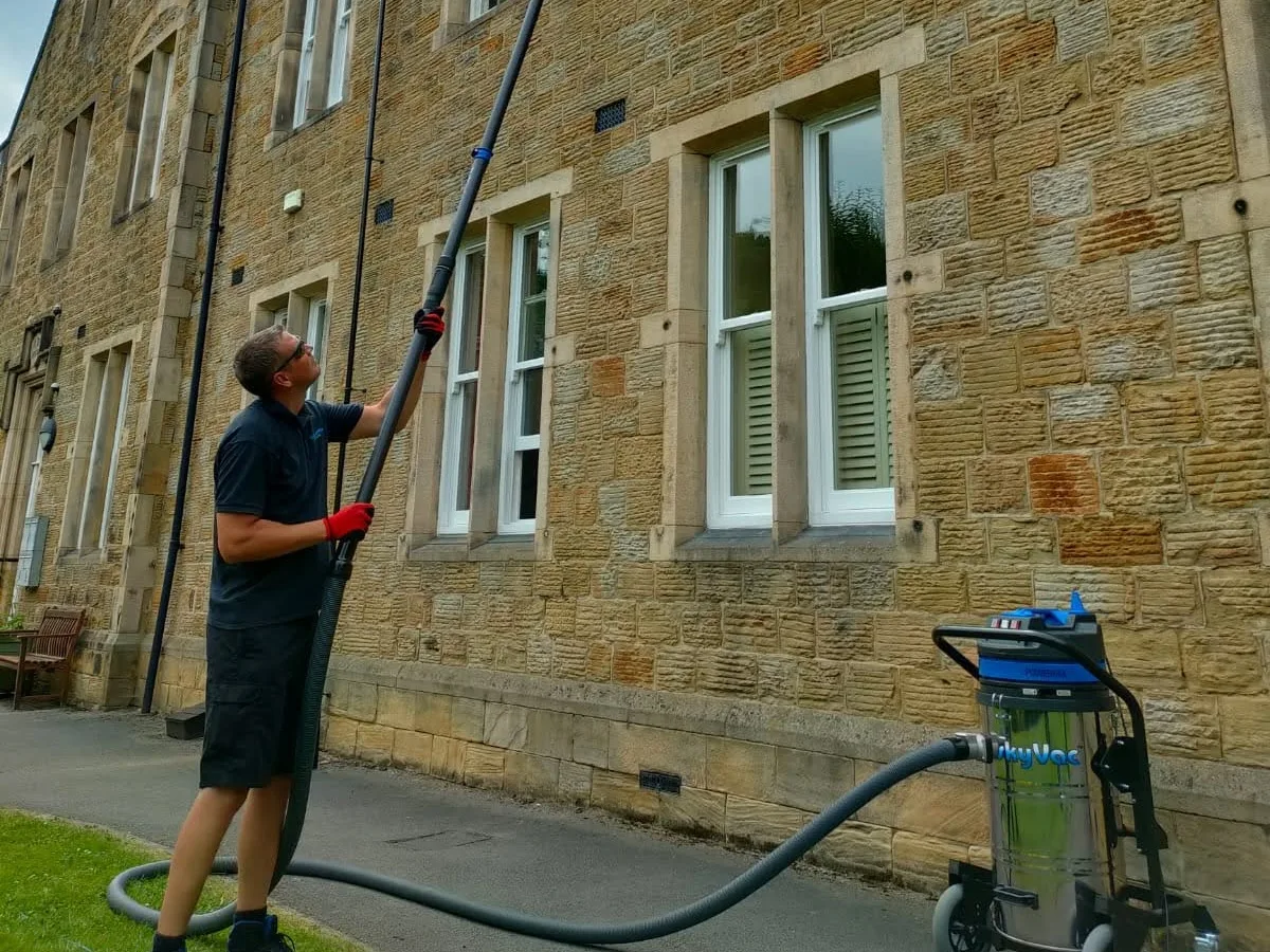 Commercial gutter cleaning from the ground with a SkyVac gutter vacuum